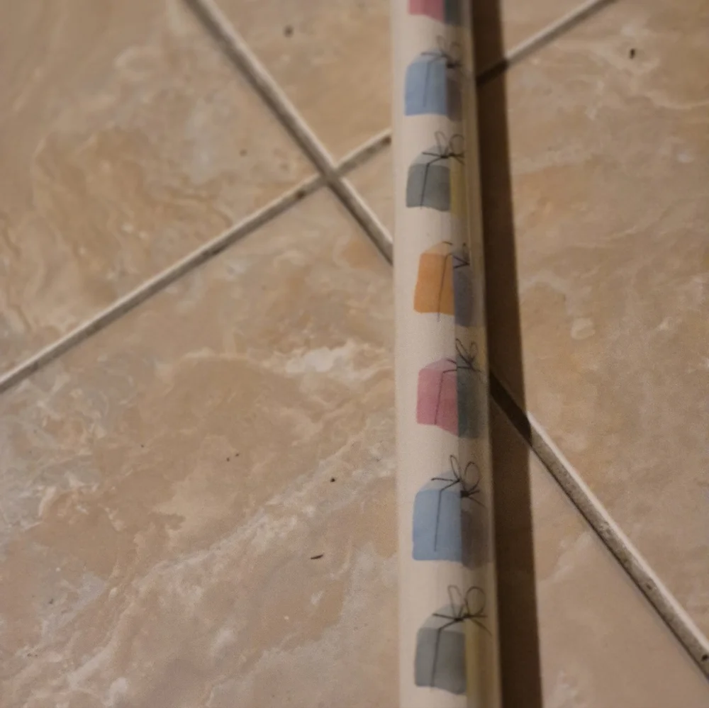 ÖNSKA wrapping paper from IKEA.  In a multi colored with white background in a c